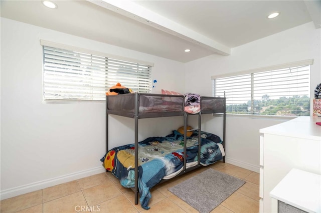 tiled bedroom featuring beam ceiling