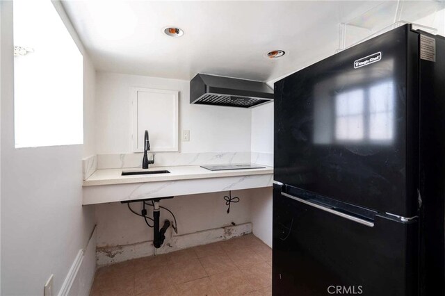 kitchen featuring sink, wall chimney exhaust hood, and black appliances