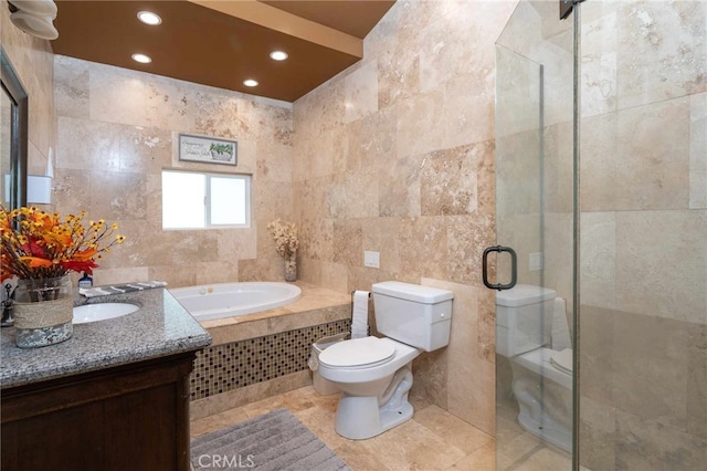 full bathroom with separate shower and tub, vanity, tile walls, and toilet