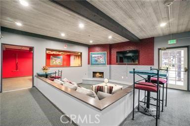 home theater with beam ceiling and dark carpet