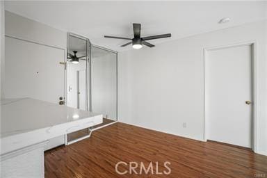 interior space featuring ceiling fan and dark wood-type flooring