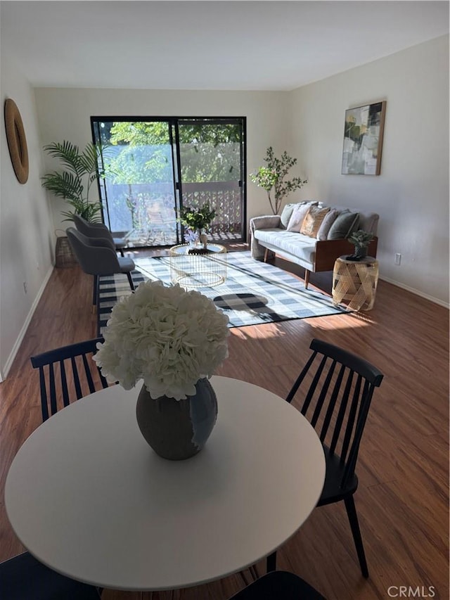 dining area featuring baseboards and wood finished floors