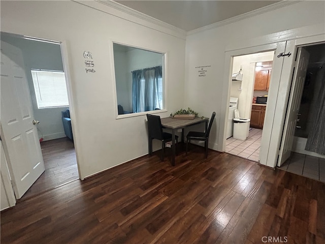 hall with ornamental molding, washer / clothes dryer, and dark hardwood / wood-style floors