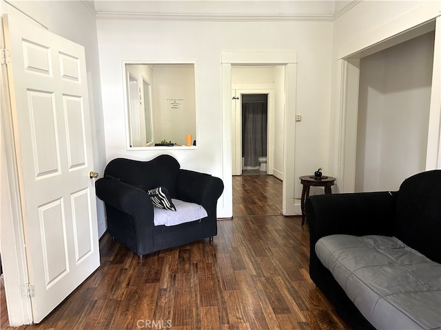 living room featuring crown molding and dark hardwood / wood-style flooring