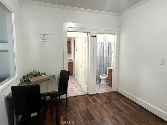 dining space with wood-type flooring and crown molding