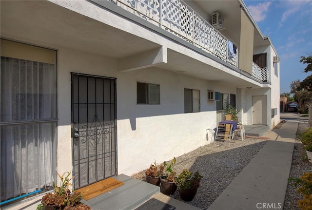 entrance to property with a balcony and a patio area