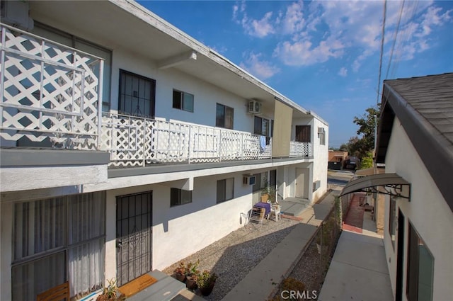 view of building exterior with a wall unit AC