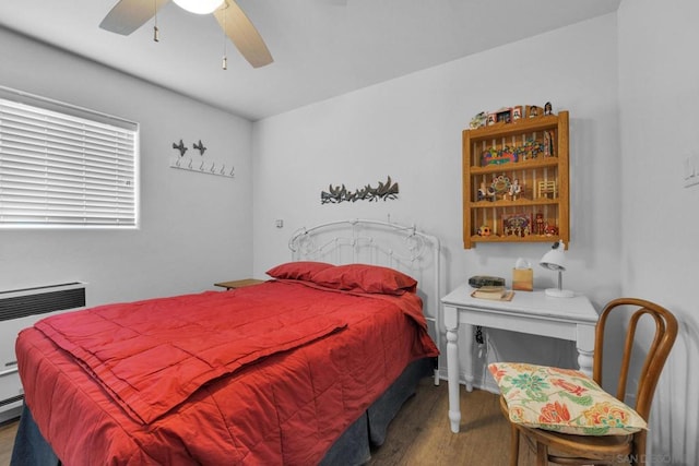 bedroom with ceiling fan and hardwood / wood-style flooring