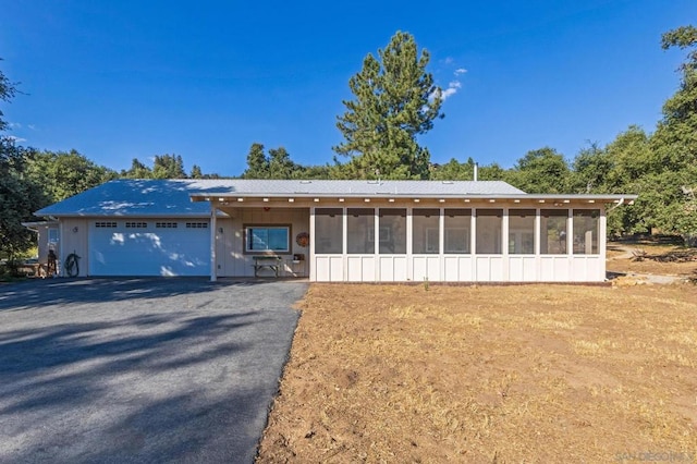 view of front of home featuring a sunroom