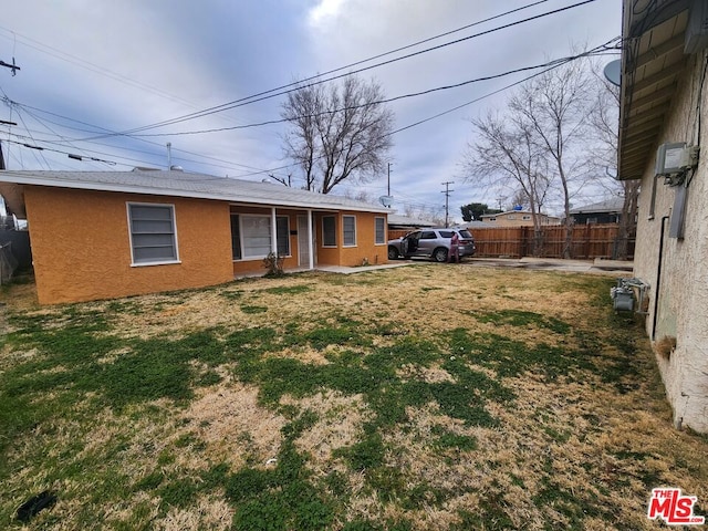 back of property featuring a lawn