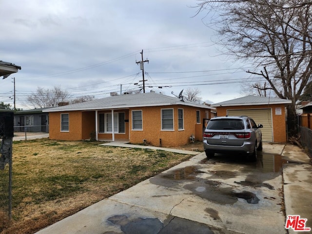 single story home with a garage and a front lawn