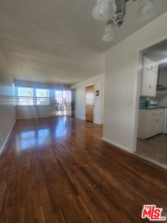 unfurnished living room with dark hardwood / wood-style floors