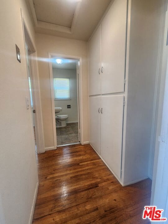 corridor with dark wood-type flooring