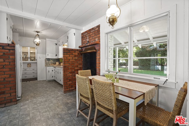 dining room featuring beamed ceiling