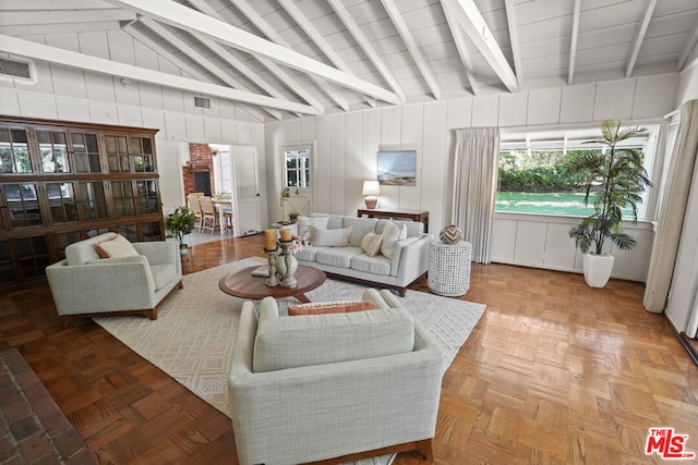 living room featuring vaulted ceiling with beams and light parquet flooring