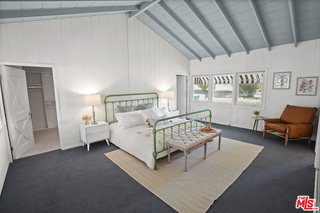 bedroom with a spacious closet, beamed ceiling, a closet, dark carpet, and wooden walls