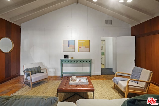 living room with parquet flooring, beam ceiling, and high vaulted ceiling