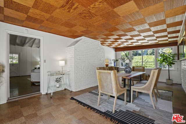 dining space with brick wall