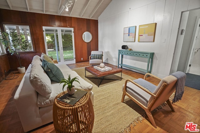 living room with vaulted ceiling with beams, wooden walls, and parquet flooring