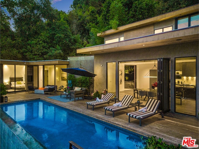 view of swimming pool featuring an outdoor living space and a patio area