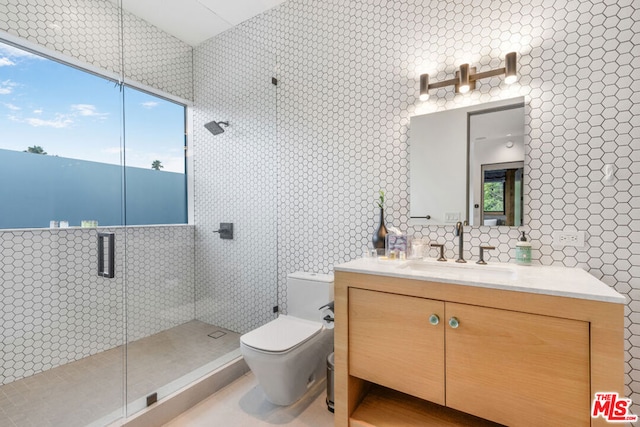 bathroom featuring a healthy amount of sunlight, tile walls, vanity, and toilet