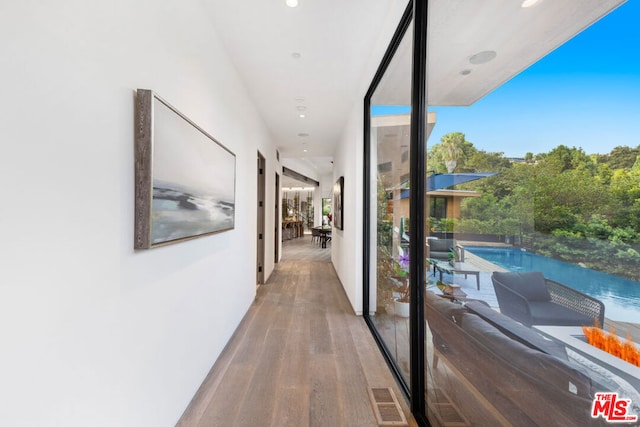 hallway featuring a water view and hardwood / wood-style flooring