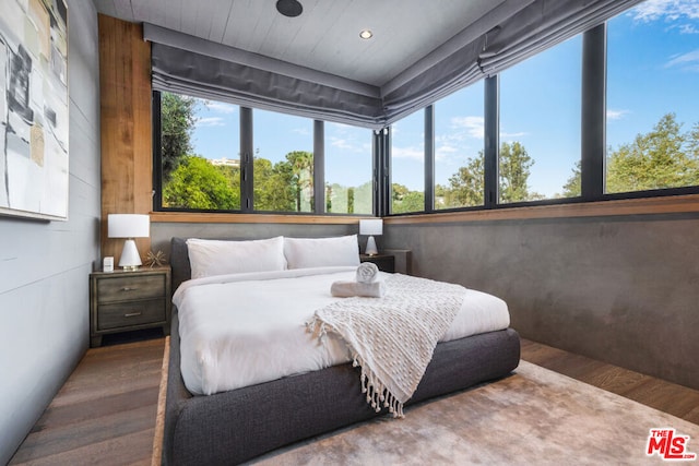 bedroom with hardwood / wood-style flooring