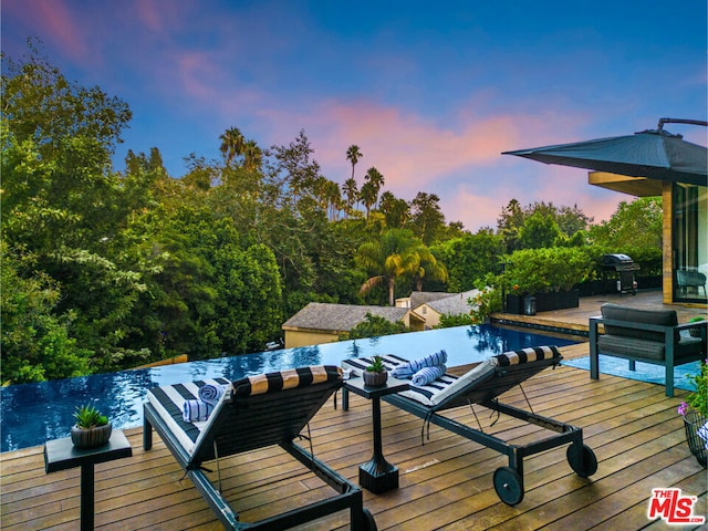 deck at dusk with grilling area