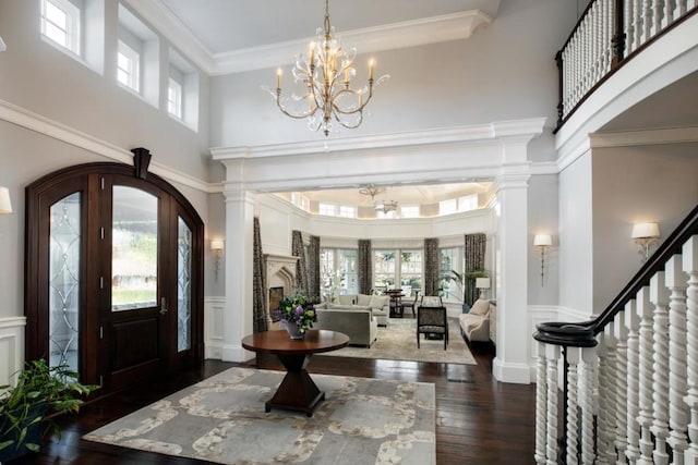 entrance foyer featuring french doors, plenty of natural light, a high ceiling, and a notable chandelier