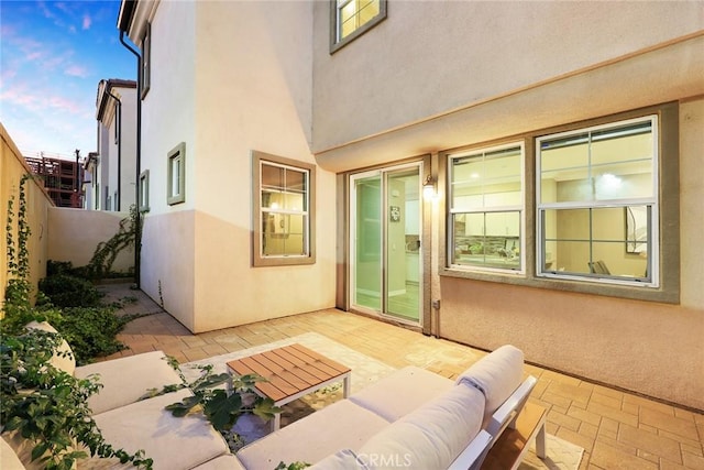 patio terrace at dusk featuring outdoor lounge area