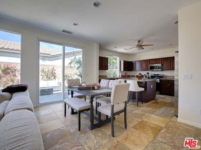 dining room with a healthy amount of sunlight and ceiling fan