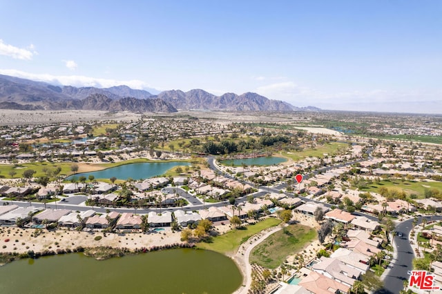 drone / aerial view with a water and mountain view