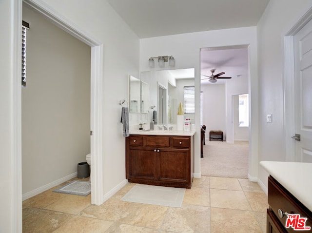 bathroom with ceiling fan, vanity, and toilet