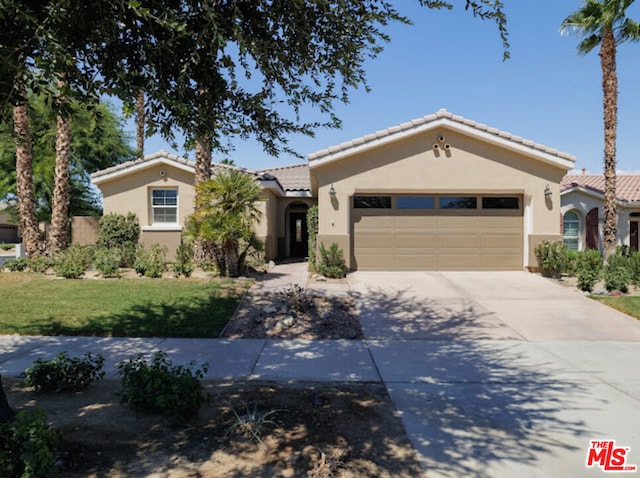 view of front of house with a front yard and a garage