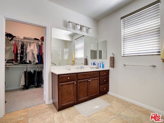 bathroom featuring vanity and an enclosed shower