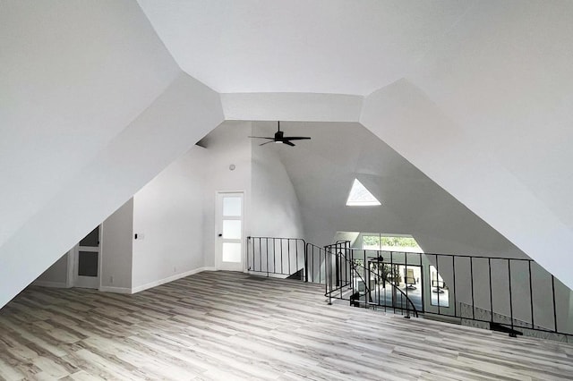 additional living space featuring plenty of natural light, vaulted ceiling, and light wood-type flooring