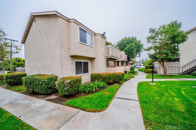 view of property exterior with a lawn