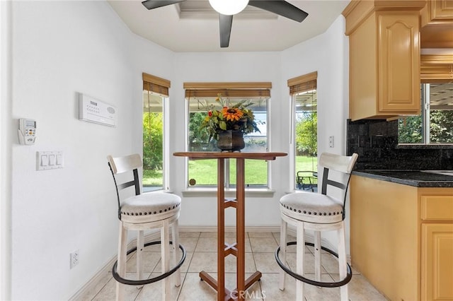 dining area featuring light tile patterned floors, ceiling fan, and a healthy amount of sunlight