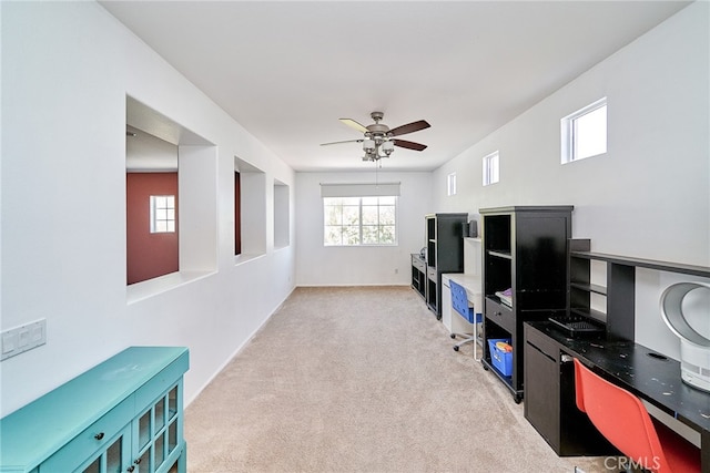 interior space featuring light carpet and ceiling fan