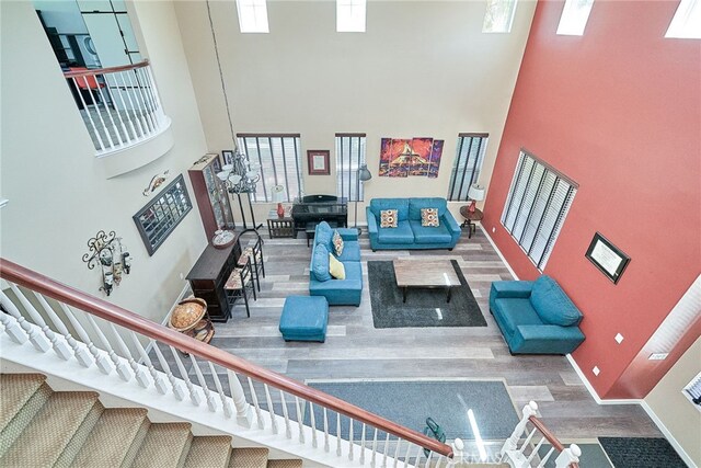 living room with a towering ceiling and hardwood / wood-style floors