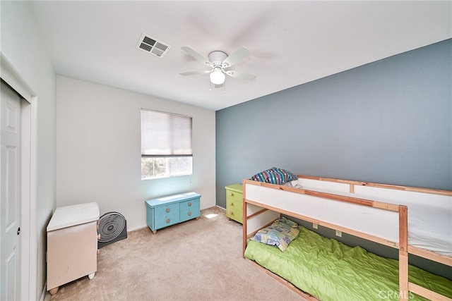 bedroom featuring a closet, ceiling fan, and light colored carpet