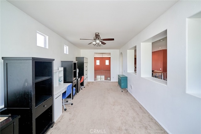 office space featuring ceiling fan and light colored carpet