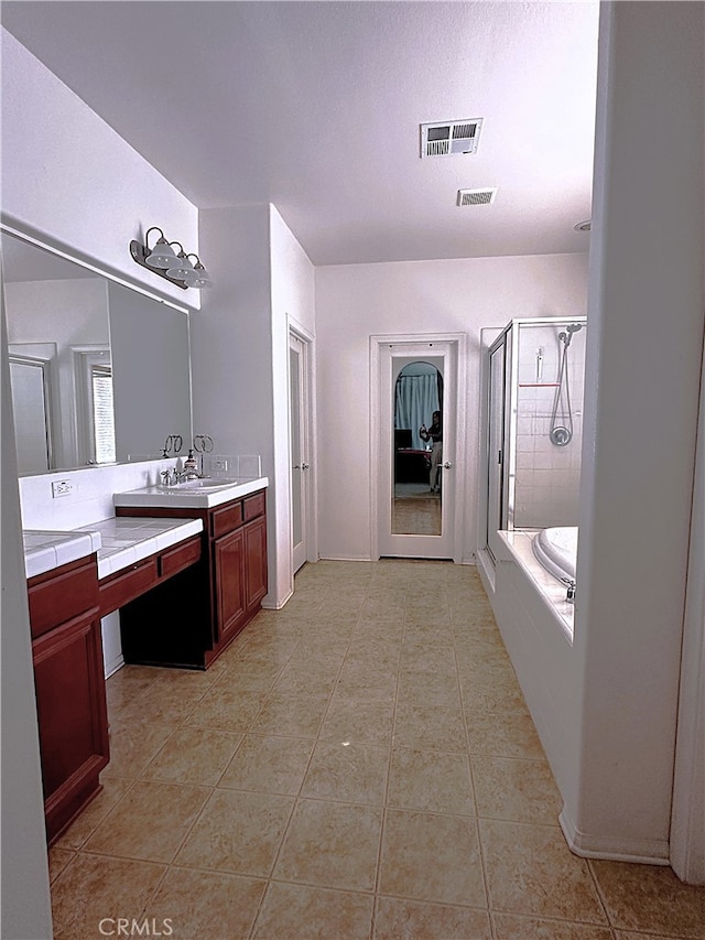 bathroom featuring vanity, plus walk in shower, and tile patterned floors