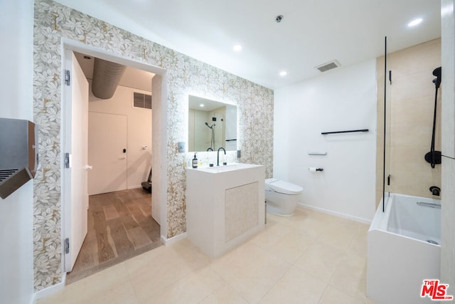 full bathroom with tiled shower / bath, vanity, toilet, and tile patterned flooring