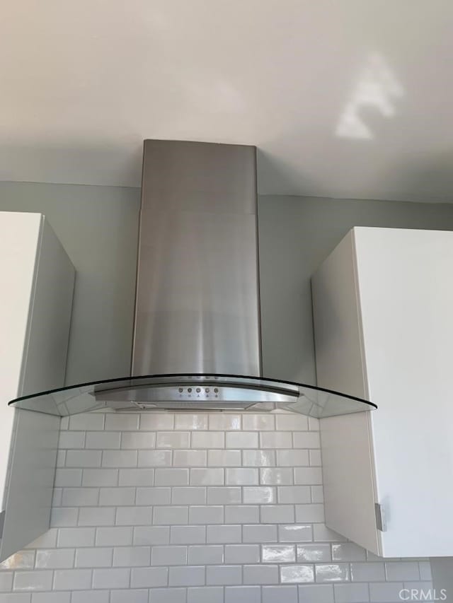 kitchen featuring wall chimney range hood