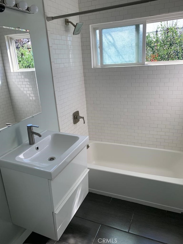 bathroom featuring vanity, tile patterned floors, and tiled shower / bath