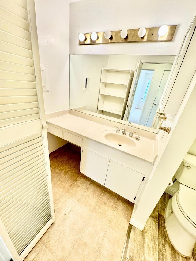 bathroom featuring toilet, vanity, and tile patterned floors