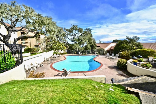 view of swimming pool with a lawn and a patio