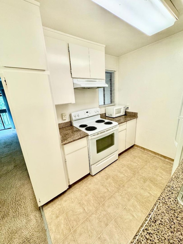 kitchen with white cabinets, light colored carpet, and white appliances