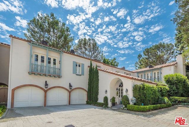 mediterranean / spanish-style home featuring a garage